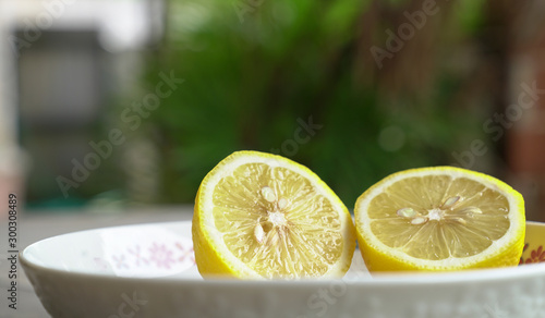 Lemon cut into half on a whilte plate