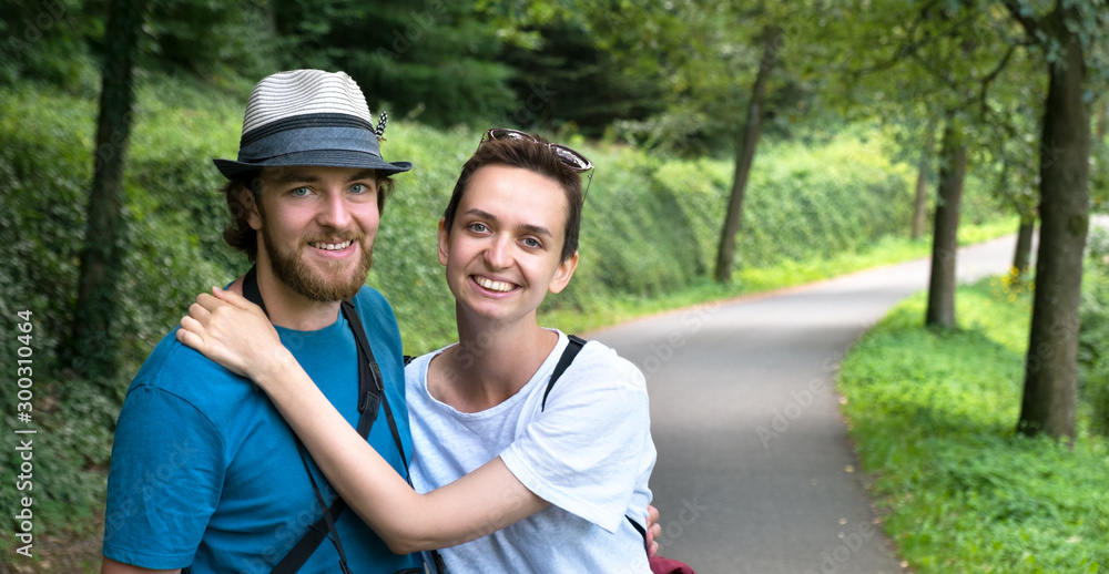 Сouple are walking in a beautiful forest on a hiking trip Сouple are walking in a beautiful forest on a hiking trip
