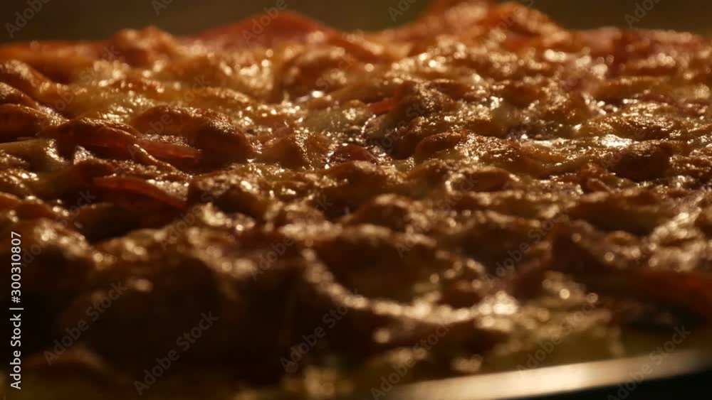 Cheese on pizza melts from oven heat. Tasty Italian pizza salami and cheese roasted in the oven close up view Cheese on pizza melts from oven heat. Tasty Italian pizza salami and cheese roasted in the oven close up view