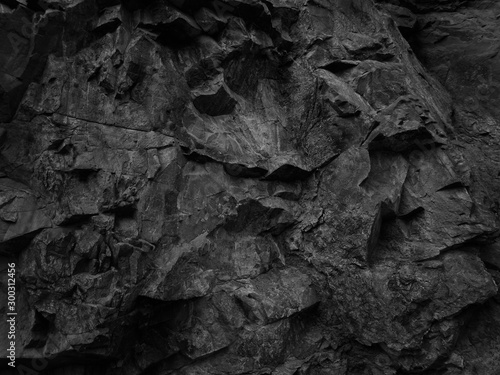 Black abstract grunge backdrop for your design. Dark  rock texture. Part of the mountain close-up.
