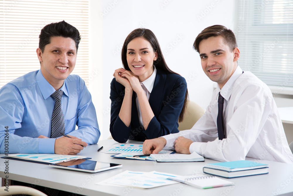 Young business people smiling looking at camera Young business people smiling looking at camera