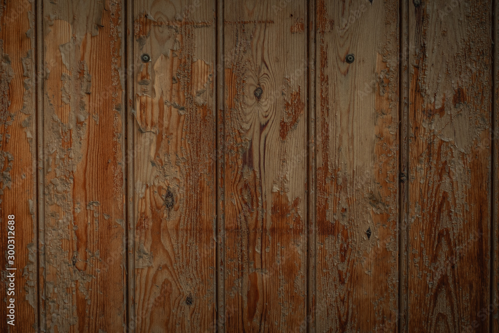 Naklejka premium Dark brown wooden boards with a worn surface. Old wooden background texture with vertical pattern.