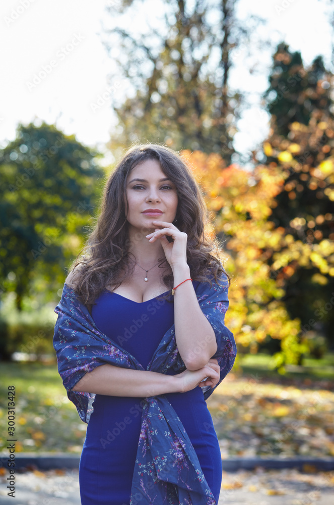 Beautiful attractive girl posing in the park. The bright colors of fall Beautiful attractive girl posing in the park. The bright colors of fall