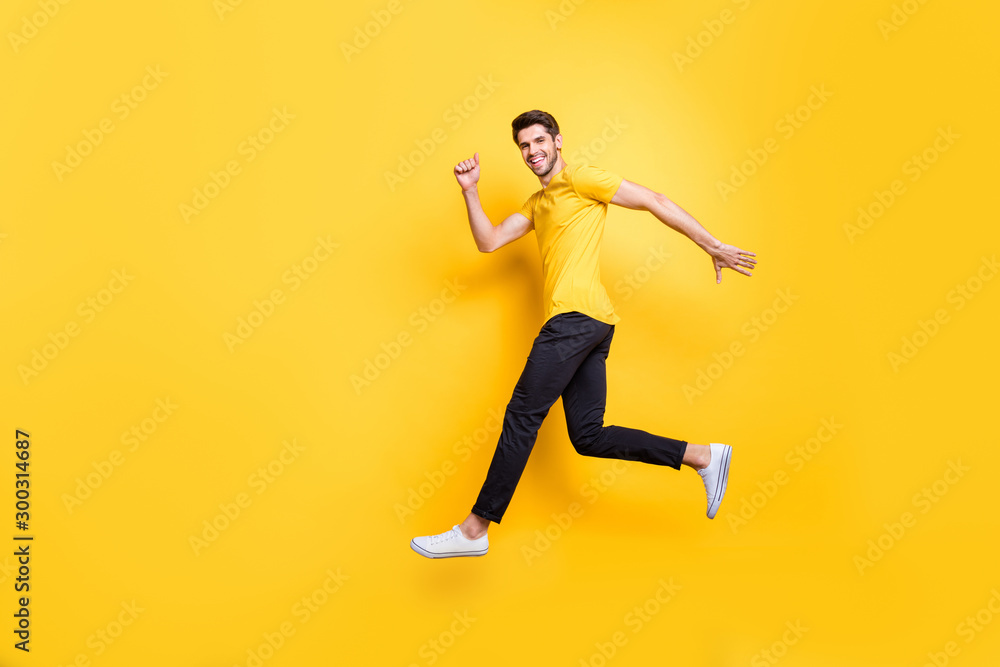 Full length body size view of his he nice attractive sportive cheerful cheery guy running fast motivation isolated over bright vivid shine vibrant yellow color background