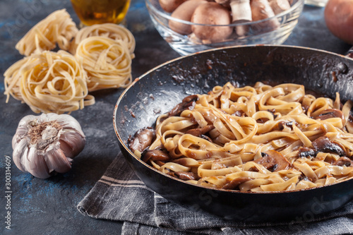 Tagliatelle pasta with champignion mushrooms photo