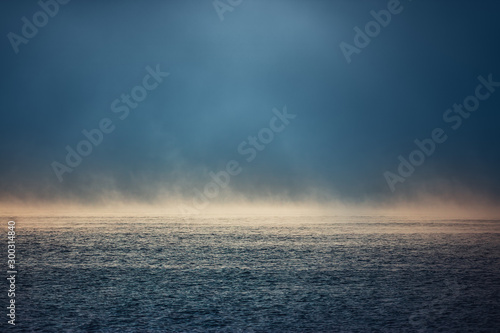 Sea sunrise and foggy morning. Fog above blue ripple water, aerial view © ValentinValkov