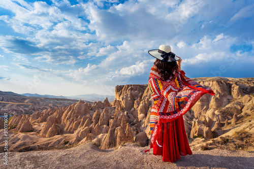 Woman standing on mountains in Cappadocia, Turkey.
