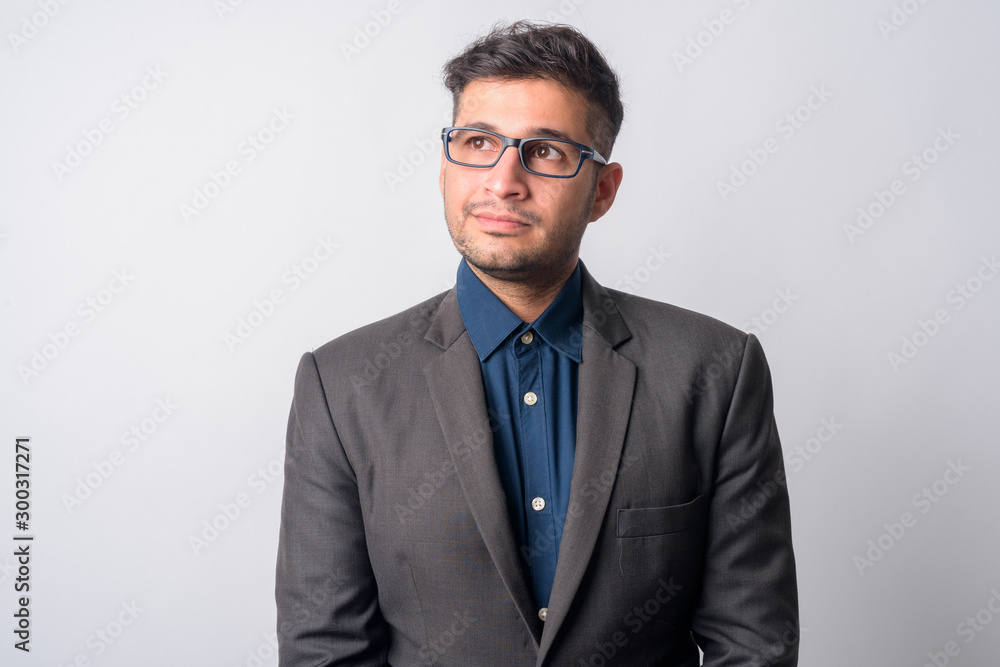 Portrait of young Persian businessman with eyeglasses thinking Portrait of young Persian businessman with eyeglasses thinking