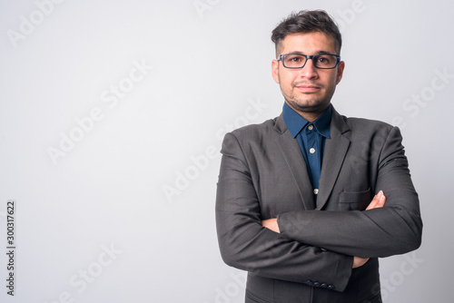 Portrait of young Persian businessman in suit with arms crossed