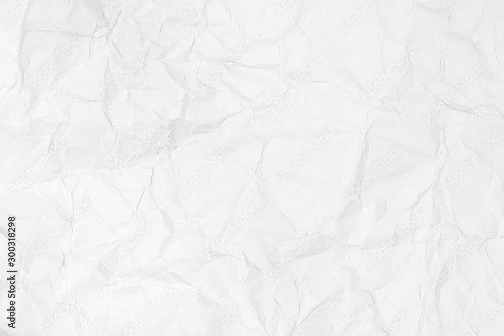 Textured background of crumpled white paper crumpled and spread.