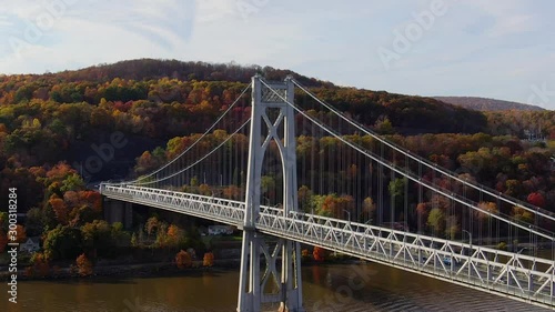 Aerial orbiting Mid-Hudson Bridge with colorful Autumn foliage Upstate NY