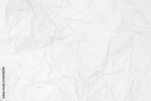 Textured background of crumpled white paper crumpled and spread.