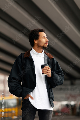 Portrait of African man with cup of coffee, happy and relaxing lifestyle.