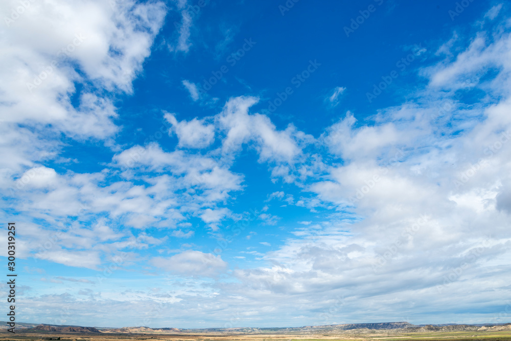 Spring sky with clouds above the badlands Bardenas Reales in the southeast of Navarre