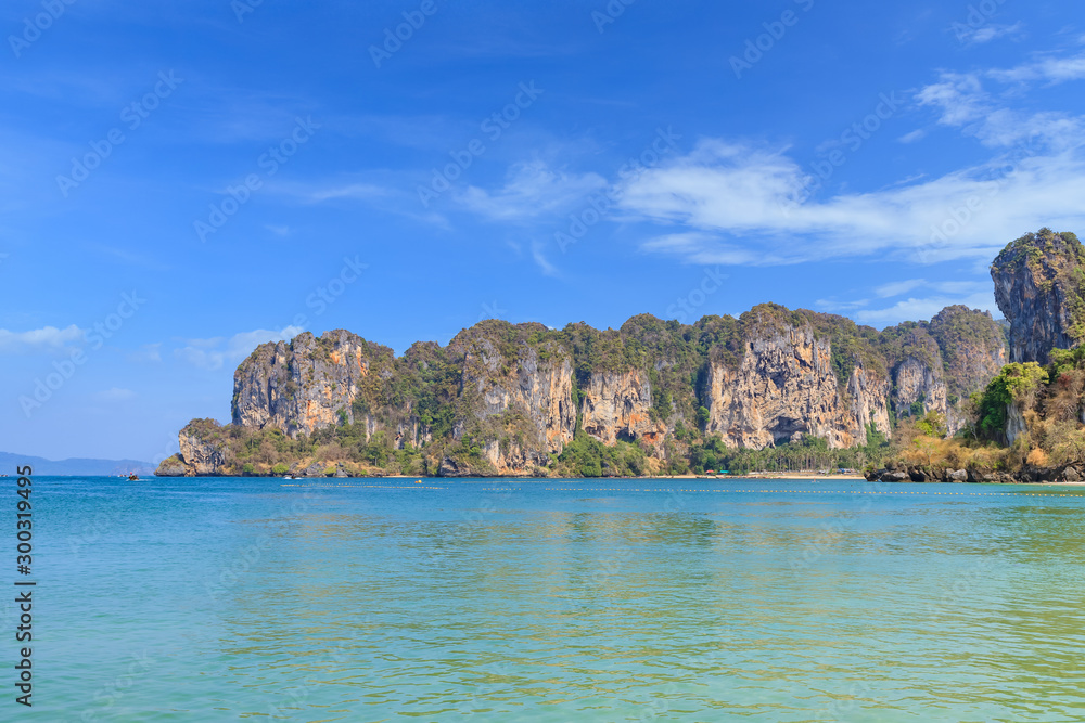 Long tail boat and beautiful sand with crystal clear sea at Railay beach, Krabi, Thailand.