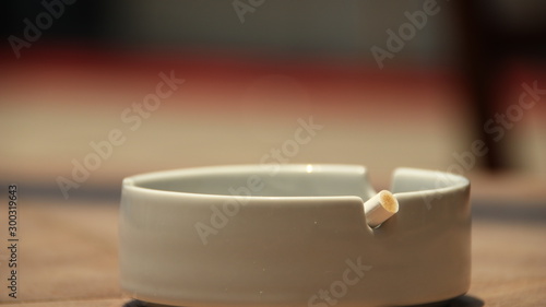 cigarette ashtray on the table, in a photo with a blurry background and selective focus
