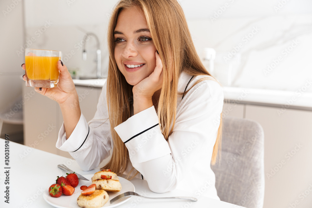 Photo of attractive lovely woman having breakfast and smiling Photo of attractive lovely woman having breakfast and smiling