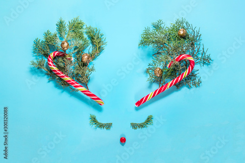 The concept of Christmas deer; the horns of Christmas reindeer candy stick; Christmas card with copy space