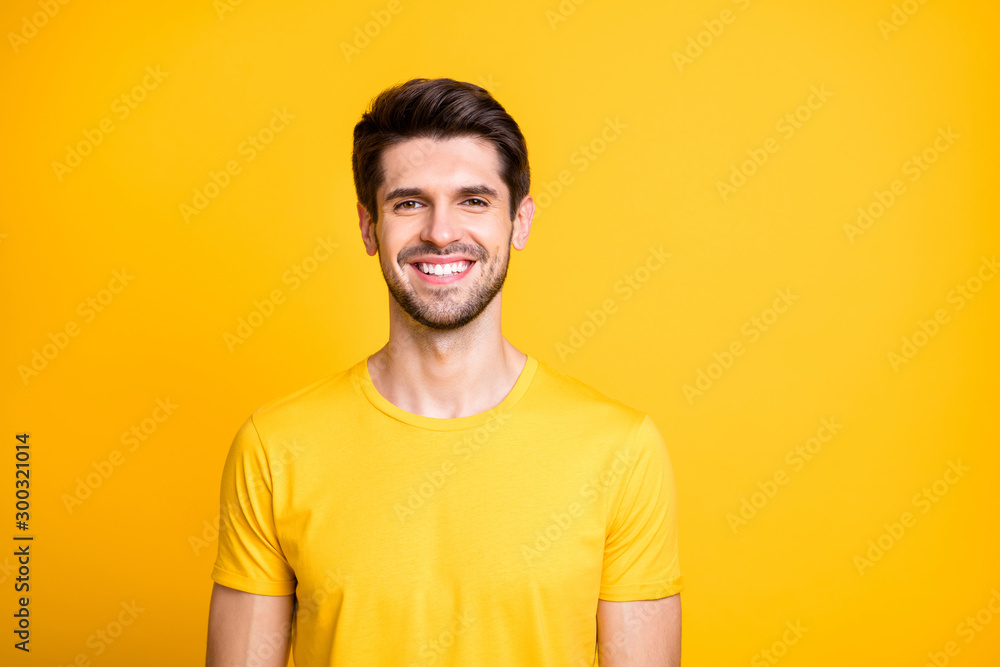 Close-up portrait of his he nice attractive cheerful cheery guy wearing tshirt smiling isolated over bright vivid shine vibrant yellow color background Close-up portrait of his he nice attractive cheerful cheery guy wearing tshirt smiling isolated over bright vivid shine vibrant yellow color background