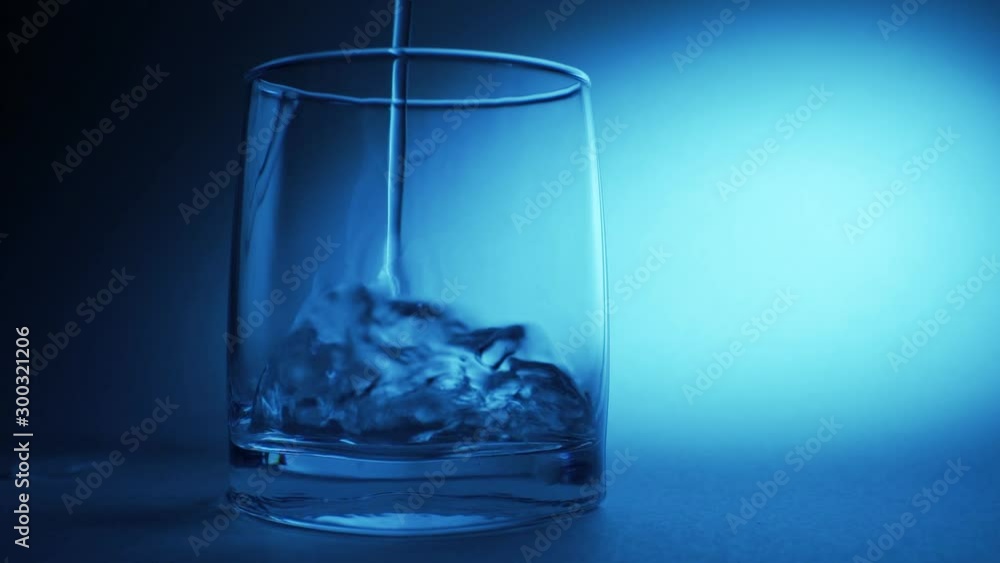 Pouring fresh pure water from bottle into a glass on the table, health and diet concept, Pouring fresh pure water from bottle into a glass on the table, health and diet concept,