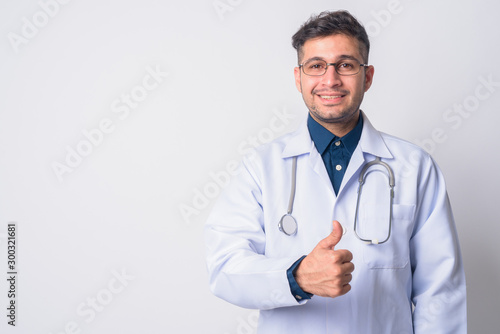 Portrait of happy Persian man doctor giving thumbs up