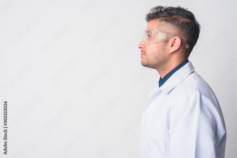 Closeup profile view of young Persian man doctor as scientist Closeup profile view of young Persian man doctor as scientist