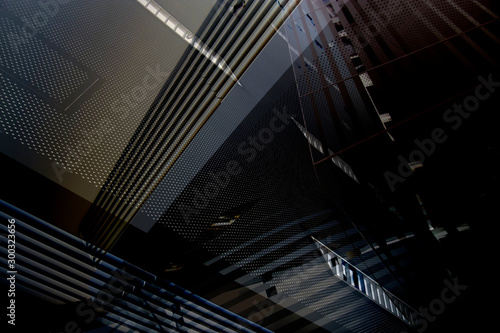 Collage photo of modern office architecture in darkness. Generic architectural elements. Grunge structure of building interior with lath ceiling and perforated metal panels.