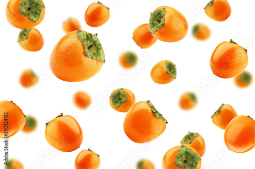 Falling persimmon isolated on white background, selective focus