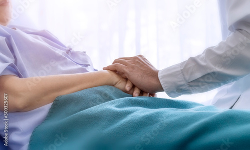 Elderly patient care concept  Asian doctor is taking care elderly patient woman in hospital.