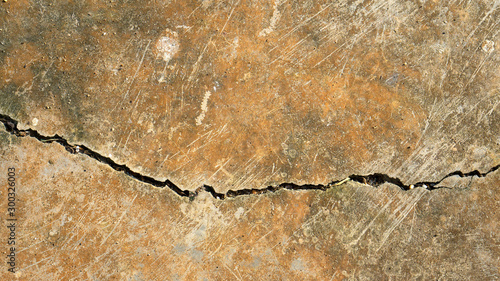 Cracked cement floor texture background,old concreat floor with brown and green lichen,copy space for add text.