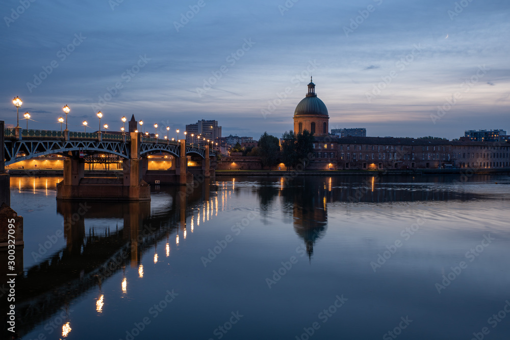 Fototapeta premium View of Chapelle Saint-Joseph and bridge Pont Saint-Pierre from the square Place Saint-Pierre at Sunset in Toulouse France