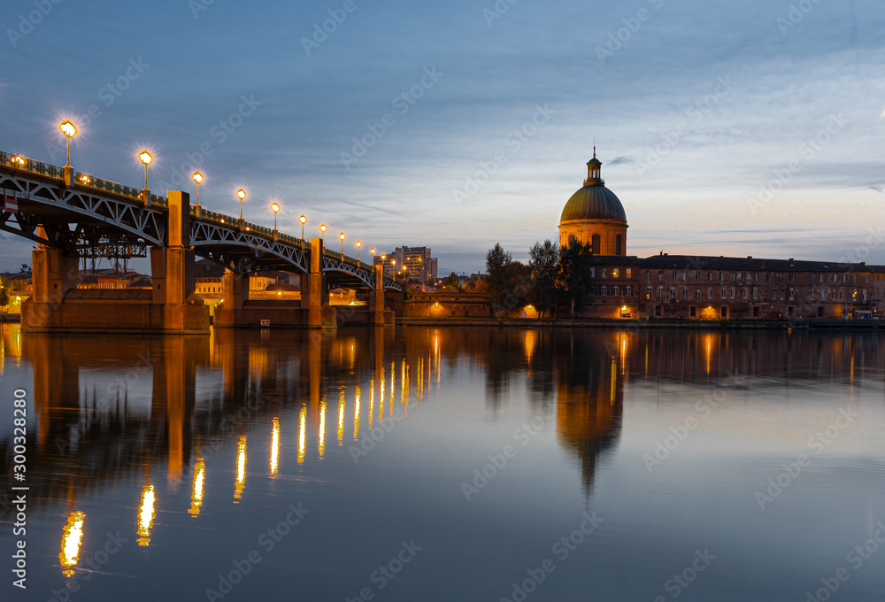 View of Chapelle Saint-Joseph and bridge Pont Saint-Pierre from the square Place Saint-Pierre at Sunset in Toulouse France