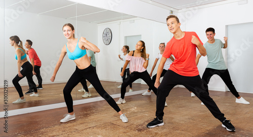 Teenagers participating in dance class with teacher