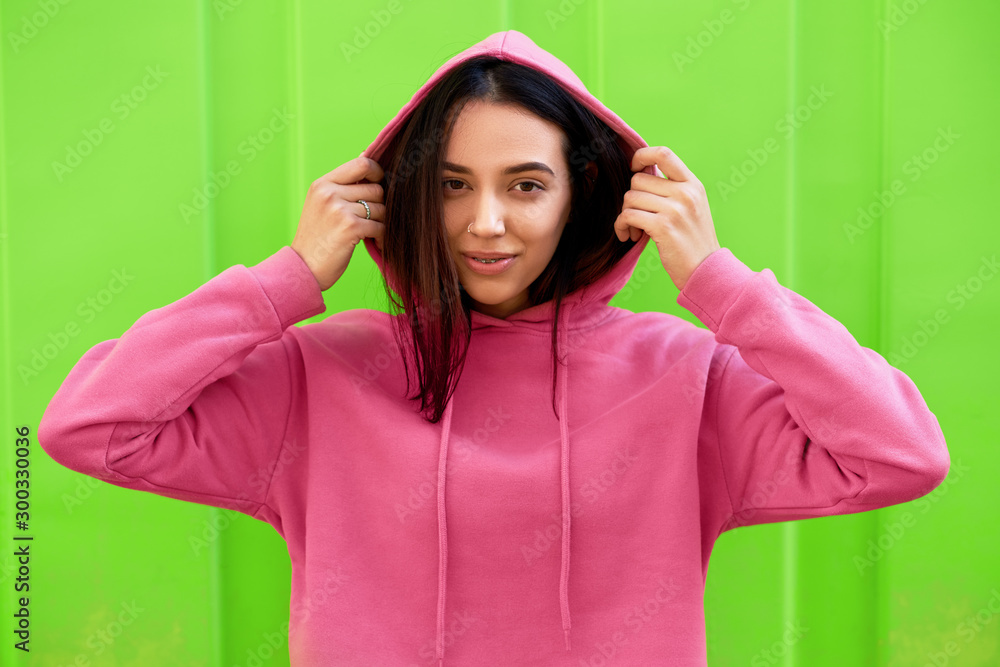 Ταπετσαρία Portrait of young teenage girl smiling and looking directly to the camera, wearing pink hoodie