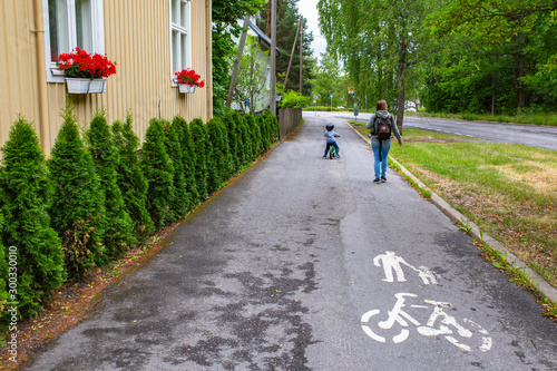 A mother and child walk down one of the numerous bicycle and pedestrian common throughout Turku and other cities in Finland.