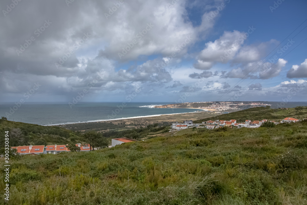 View at the Nazare Village with touristic beach, atlantic ocean and sky
