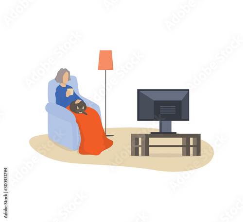 Happy old woman sitting in the armchair and watch TV