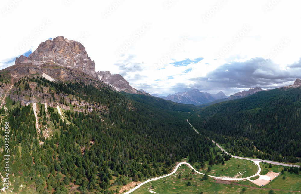 Aerial view of Cortina d'Ampezzo surrounded by majestic mountains. Dolomites National Park. UNESCO World Heritage Site. summer day, Passo Falzarego road. Free Parking