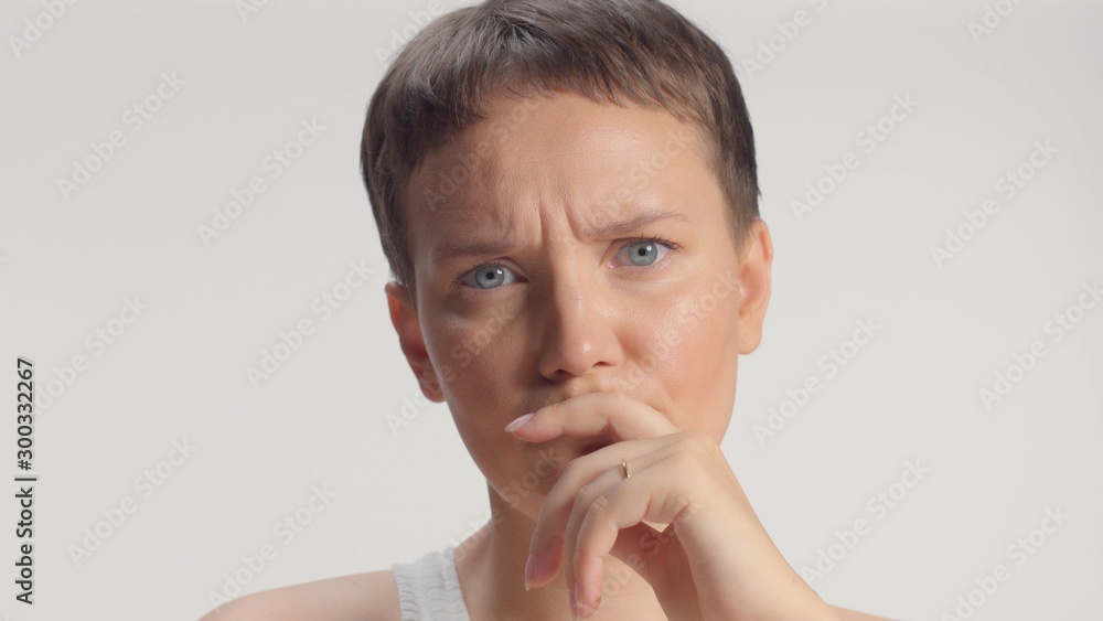 Woman in studio making faces looking bothering and think-full serious face Woman in studio making faces looking bothering and think-full serious face