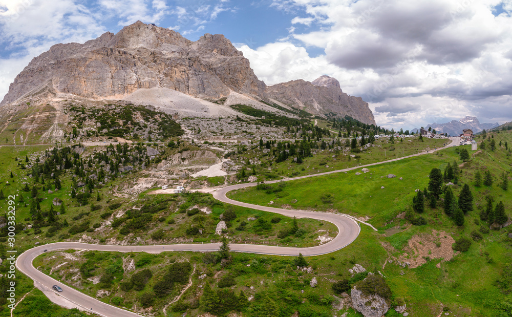 Aerial view of winding road surrounded by mountains, beautiful roads for traveling by motorcycle or car, the way of hikers and and cyclists, Falzarego Pass, Dolomites, Italy. Cortina d’Ampezzo.