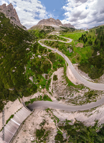 Aerial view of winding road surrounded by mountains, beautiful roads for traveling by motorcycle or car, the way of hikers and and cyclists, Falzarego Pass, Dolomites, Italy. Cortina d’Ampezzo. photo