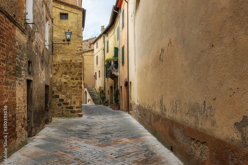 Amazing view with a narrow picturesque medieval street of old town of Pienza in Tuscany, Italy
