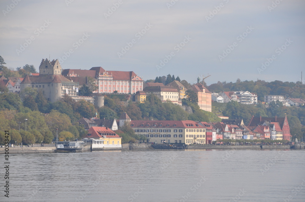 seagulls flying over the Lake Constance with the old town of Meersburg in the background, Baden-Württemberg, Germany