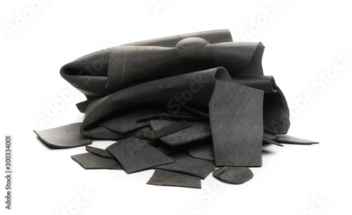 Black rubber scraps for recycling, isolated on white background photo