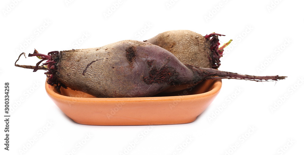 Fresh raw beetroot slices in clay pot isolated on white background 