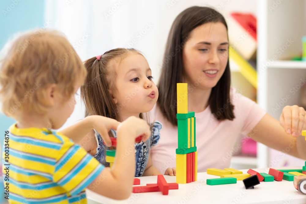 Kids with teacher in kindergarten or daycare Kids with teacher in kindergarten or daycare
