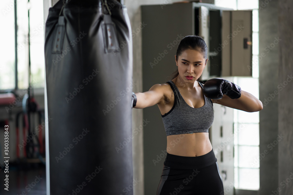Strong woman practice Thai boxing in gym