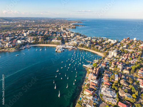 Aerial drone evening view of the Sydney suburb of Manly, a beach-side suburb of northern Sydney, in the state of New South Wales, Australia. Manly Harbour in the foreground, Manly Beach in the back.