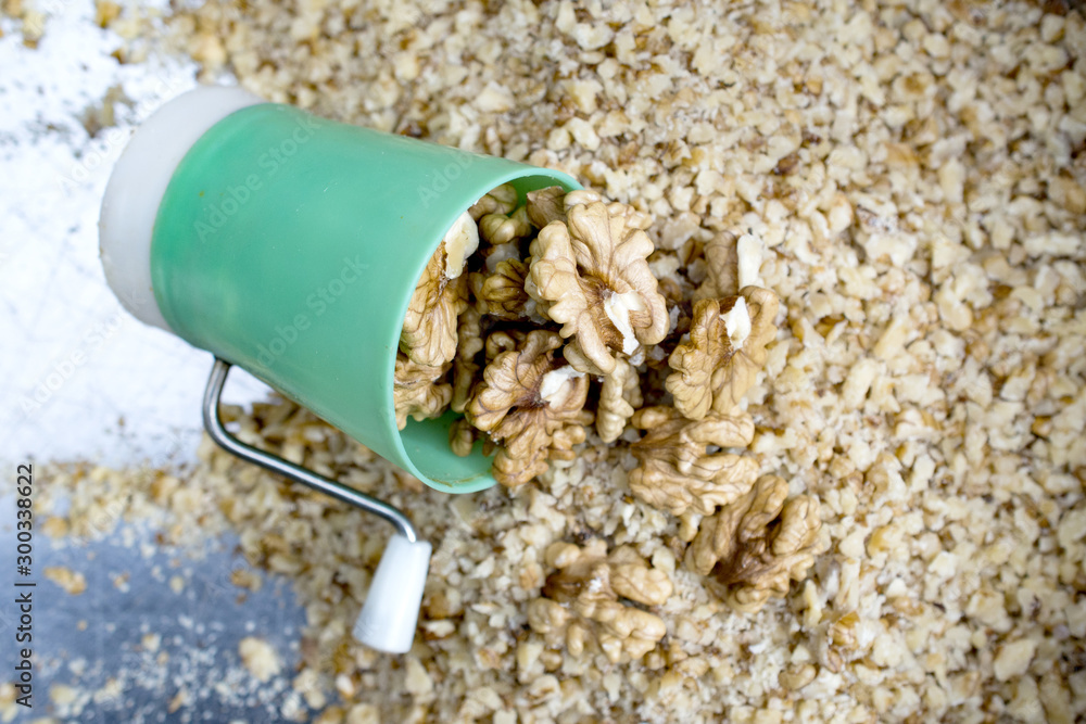 walnuts on a small green nut grinder walnuts on a small green nut grinder