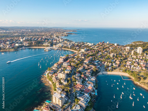 Aerial drone evening view of Manly, a beach-side suburb of northern Sydney in the state of New South Wales, Australia. Little Manly Beach in the foreground, Manly Harbour & Manly Beach in background.  photo